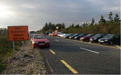 Cars and people gather