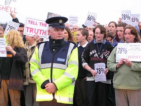 Protestors recite the Rosary as Seargent Gill pretends not to notice (unsuccessfully)