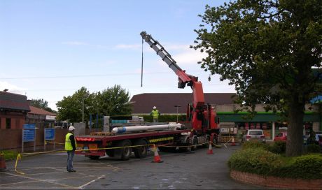 The truck bearing the flagpole/ mast is prepared to leave the Hartstown petrol station.