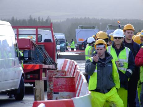 Far from being intimidated, the workers on site are curious, and taking photos themselves.