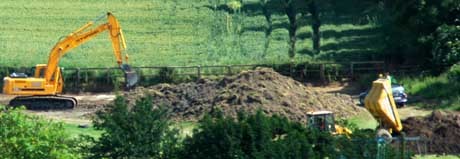 Look at the careful 'dumping' by the tipper truck on the bottom right.. Read comments above.. Ignore the digger, look at the tipper truck and the 2 Archaelogists behind the car..