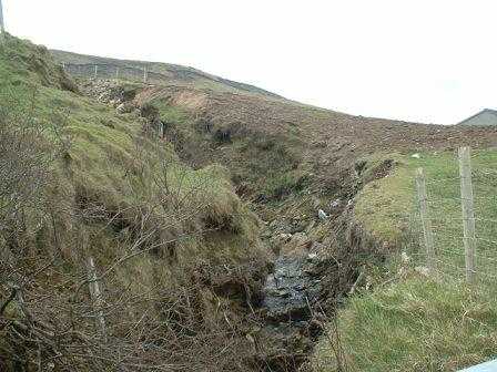 In the background you can see the holes left by the peat slide