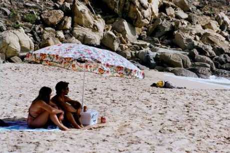 Sunbathers ignore a migrant's corpse, Tarifa, Spain
