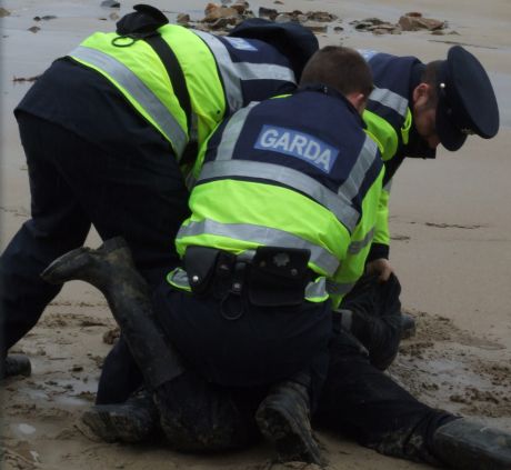 The Guards assault Iollan - they're shoving his face into the wet sand and worse!